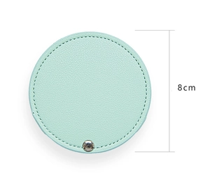Detail view of a mint green PU leather mini mirror sleeve with metal snap and 8cm diameter
