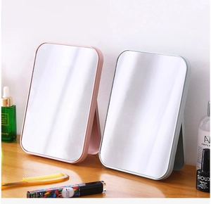 Detail view of foldable tabletop vanity mirrors in pastel pink and light blue colors