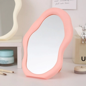 Pink irregular cloud-shaped desk makeup mirror with a stylish wave-edge matte plastic frame