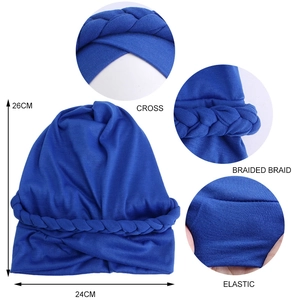 Detail view of royal blue braided turban hat showing elastic knit fabric and size dimensions