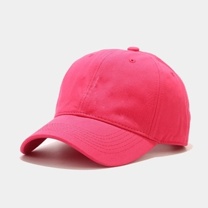 Detail view of pink cotton twill baseball cap with curved brim and 6-panel stitching