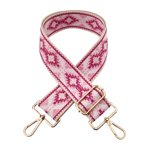 Detail of bohemian jacquard wide bag strap with pink geometric embroidery and gold hooks