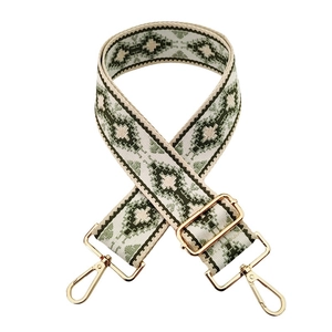 Detailed macro shot of vintage jacquard weave strap with gold adjustable metal hardware