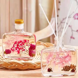Preserved flower reed diffuser in glass bottle with dried flowers and pine cones decor