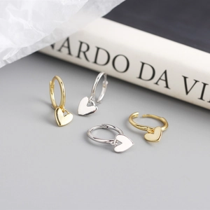 Detail of S925 sterling silver heart hoop earrings in gold and silver finishes