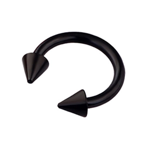 Close-up of a black circular barbell with pointed cone ends for body piercing jewelry