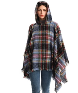 Close-up of blue plaid hooded poncho featuring tassel hem and soft textured fabric