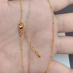 Detail of 18K gold-plated O-chain with lobster clasp, extender chain and small bead accents
