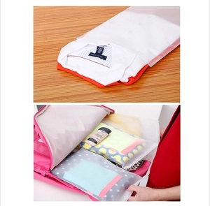 Translucent waterproof travel bags for organizing clothes inside a pink suitcase