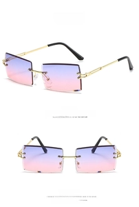 Detail of rimless rectangle sunglasses with gold frame and purple pink gradient lenses