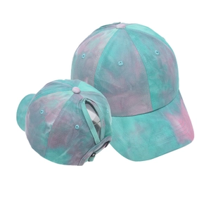 Detail view of tie-dye ponytail baseball cap showing the back opening and front peak.