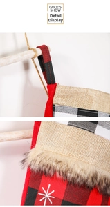Detail of red and black buffalo plaid Christmas stocking with faux fur trim and snowflake