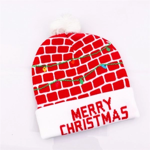 Detail of red Christmas knit hat featuring brick pattern and LED lights for parties