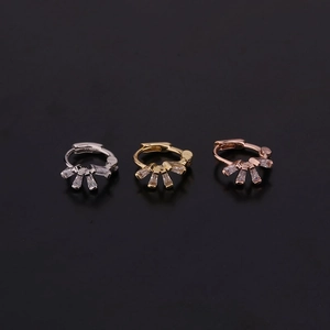 Detailed view of silver, gold and rose gold earrings with four rectangular zircon stones