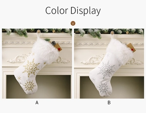 Detail view of white velvet Christmas stockings with gold and silver snowflake patterns