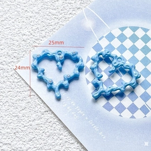 Detail shot of blue heart DIY jewelry pendant with pearl accent, 25mm size overview
