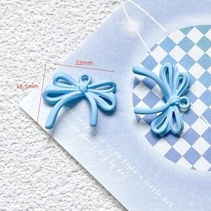 Detail view of a 22mm x 18.5mm light blue bow charm showing dimensions for DIY crafts