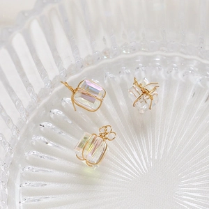 Detailed view of handmade aurora cube crystal charms with gold wire wrapping for DIY jewelry