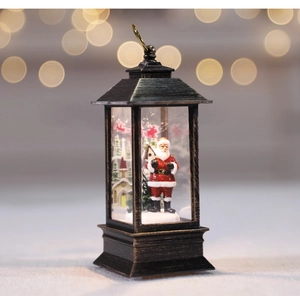 Macro view of vintage bronze Christmas lantern with Santa Claus and snow scene inside