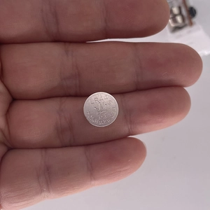 Detail view of the LR44 button cell battery for luminous Christmas tree toppers