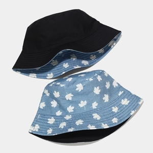 Reversible sun bucket hat in solid black and light blue maple leaf print for women