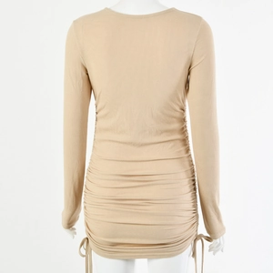 Macro view of khaki ribbed knit dress featuring adjustable side drawstrings and ruched detail
