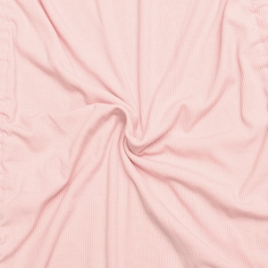 Close-up of pink ribbed fabric texture with soft drawstring pleats and spiral pattern