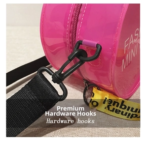 Detail of pink jelly round crossbody bag with hardware hooks and fashion strap