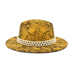 Detail of yellow snake print fedora hat featuring a triple row pearl decorative band