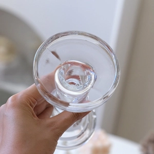 Overhead view of hand holding a luxury crystal glass candle holder with French retro design