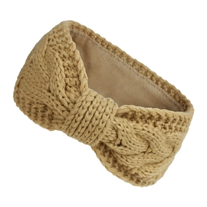 Detailed view of winter knitted headband featuring khaki cable knit and warm plush lining