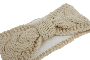 Close-up of beige cable knit headband featuring soft fleece lining and center twist detail