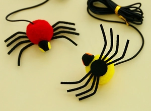 Detail of hanging spider cat toy with colorful plush balls and elastic bounce string