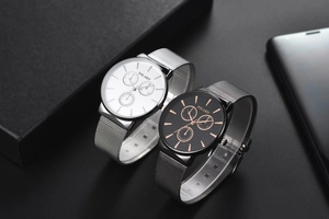 Close-up of Yolako quartz watches with mesh stainless steel bands on a black display box