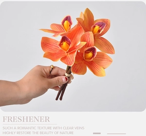 Close-up of artificial orange orchid with 3D printed petals and realistic vein textures