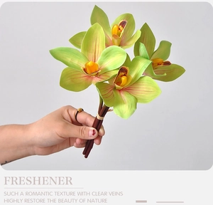 Close-up of artificial green cymbidium orchid with red veins and 3D printed texture
