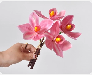 Detailed view of 4-head pink artificial cymbidium orchid flowers with vibrant yellow center