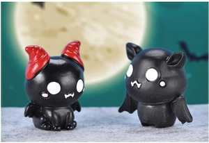 Close-up of cute cartoon black bat figurines with red horns for Halloween decor