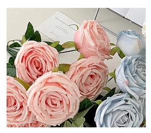 Detail of pink and light blue artificial roses with realistic silk petals for home decor