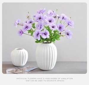 Purple faux butterfly ranunculus in minimalist white ceramic vases for home decor