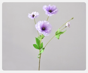 Detailed view of artificial purple ranunculus with three blooming heads and green foliage