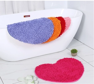 Detailed plush texture of colorful heart-shaped chenille absorbent bath mats in a bathroom