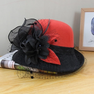Detailed shot of a red and black wool fedora with mesh net and floral accents