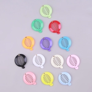 Detailed top view of 13 colorful plastic banana hair clips in various vibrant macaron shades