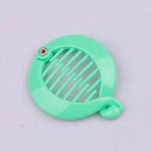 Detail view of mint green circular banana hair clip with interlocking plastic teeth