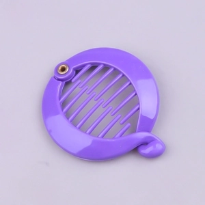 Macro detail of purple round banana hair clip showing plastic teeth and metal hinge