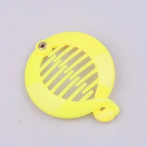 Detail view of bright yellow plastic banana hair clip with interlocking anti-slip teeth