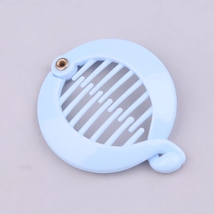 Detail view of light blue round banana hair clip with interlocking plastic teeth