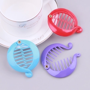 Close-up of bright plastic banana hair clips with comb teeth in red, blue and purple