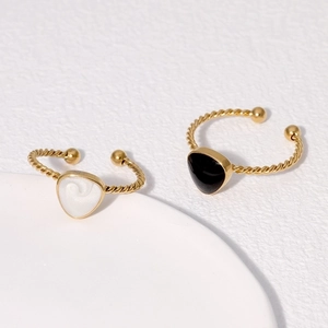 Detailed shot of gold twisted rings with black and white heart-shaped shield details
